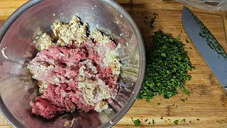 Ground beef with the panade and onions, ready to add parsley. 